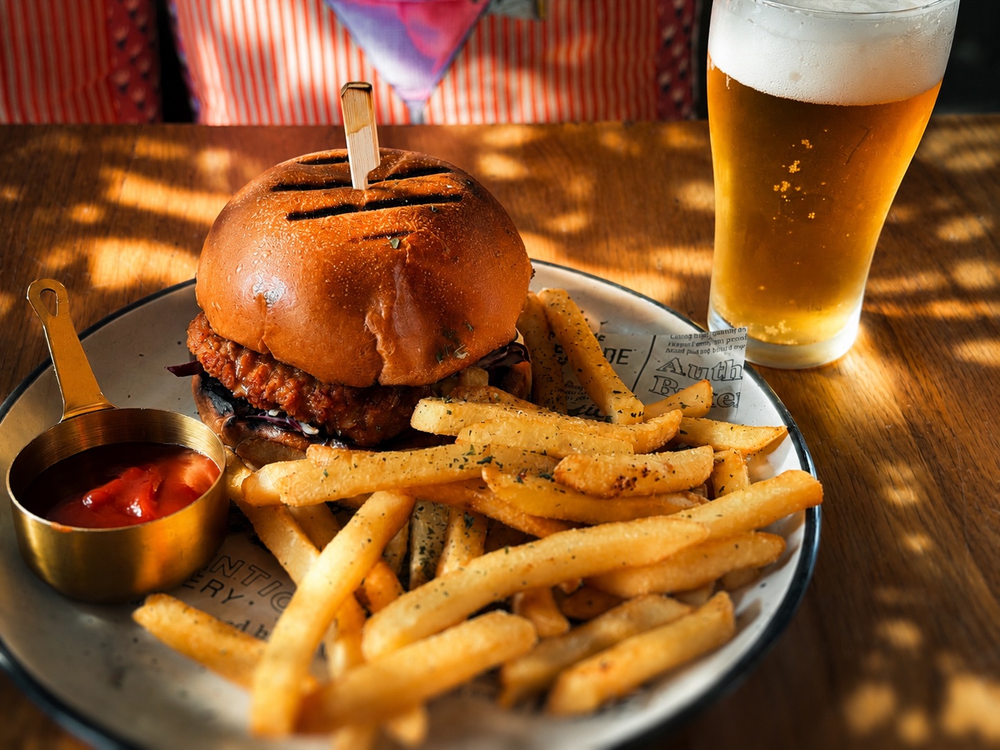 Loaded burger served with fries and a cold beer